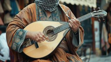 A man in a traditional outfit plays a guitar photo