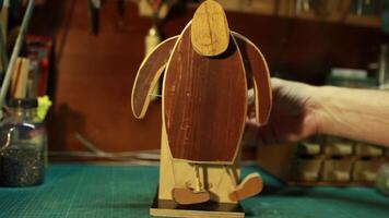 In the artist's studio, a man turns a handle, Humpty Dumpty, an automaton with sound video