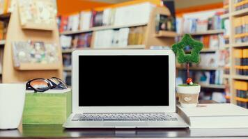 Workspace setup at a cozy bookstore with a laptop and decorative items during a quiet afternoon photo