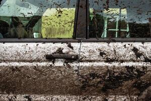 Dirty 4x4 vehicle with mud splatters on body, windows, wheels, tires. Dirty offroad suv car covered in dirt. Rugged terrain adventure, extreme driving, four wheel drive challenges 6 photo