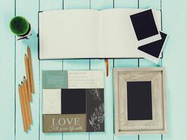 Crafting memories with an empty journal, colorful pencils, and blank frames for creative storytelling photo
