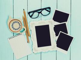 Stationery and personal items arranged on a light wooden table for creative planning and memory keeping photo