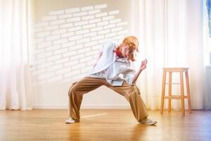 Dynamic dance performance showcasing expressive movement in a studio setting with natural light photo
