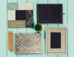Craft supplies and decorative frames arranged on a light blue wooden surface for artistic projects and creativity photo