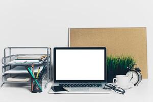 Front view of modern workplace in office with computer and supplies photo