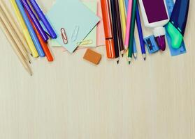 Bright and colorful stationary supplies arranged on a wooden table ready for creative projects and schoolwork sessions photo