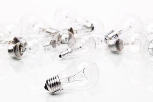 Many lightbulbs on white background close up photo