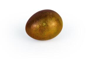 Golden brown easter egg with glowing shell pattern, isolated on white background. Color contrast, creativity, holiday decoration, creativity, symbolism of rebirth. Copy space. Selective focus 1 photo