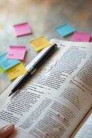 Exploring language and learning with notes and a pen on a page filled with text and colorful post-it reminders photo
