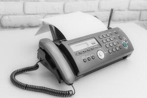 Fax machine, office equipment on white table photo