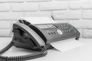 Fax machine, office equipment on white table photo