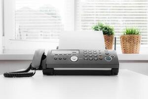 Black fax machine tool close up, business concept photo