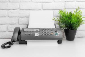 Fax machine, office equipment on white table photo