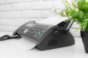 Fax machine, office equipment on white table photo