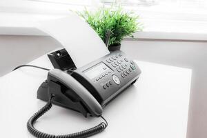 Black fax machine tool close up, business concept photo