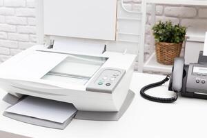 Printer and fax machine on office table photo
