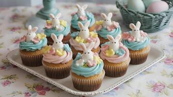 A delightful display of Easter cupcakes, adorned with charming bunny toppers and pastel-colored frosting. photo