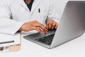 dentist with a laptop on a desk with a laptop. communication and medical technology concept. photo