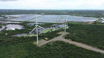 Two wind power tower with a lake in the background generation renewable energy video