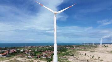 Wind power tower seen from behind with the ocean in the background video