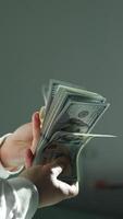 Man hold us money, counting one hundred dollar bills. Saving concept video