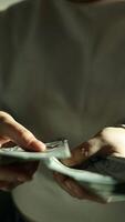 Man hold us money, counting one hundred dollar bills. Saving concept video