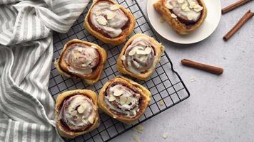 Delicious cinnamon rolls with icing on cooling rack video