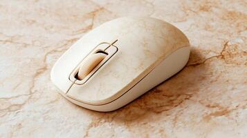A white computer mouse on a marble surface photo
