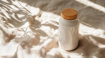 A white water bottle with a wooden lid sitting on a bed photo