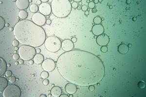 Abstract composition with water and oil drops against white and green background photo