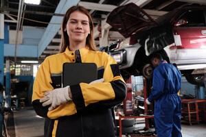 White female mechanic inspector, happy work and cheerful smile in fix car garage checklist jobs with tablet, professional engineer works in automotive and transportation industry business. photo