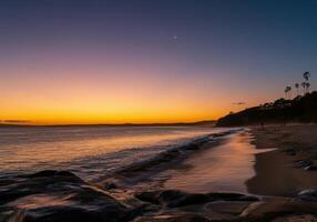 A beautiful sunset over the ocean and beach photo