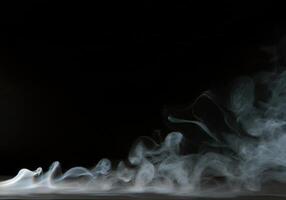 A white smoke is coming out of a black background photo