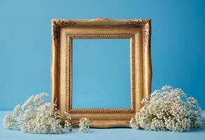 Gold frame with white flowers on blue background photo