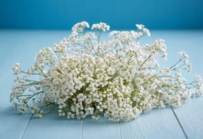 Bouquet of baby's breath on blue wooden table photo