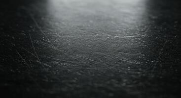 A black surface with a light shining on it photo