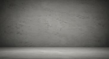 An empty room with a concrete wall and a cement floor photo