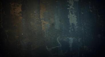 A dark blue wall with some paint on it photo