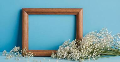 Frame with baby's breath on blue background photo