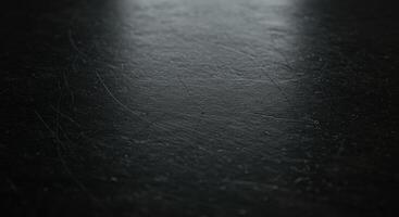 A black surface with a light shining on it photo