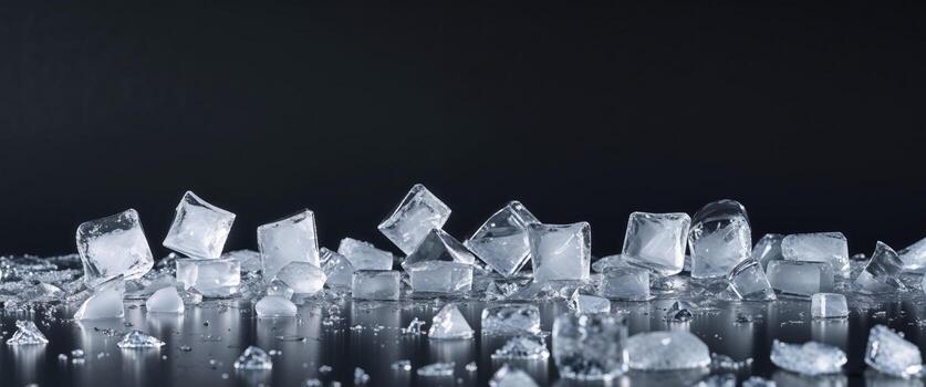 Scattered ice cubes and crushed ice on a black background with copy space for text inclusion photo