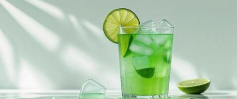 Refreshing green beverage with lime and ice. photo