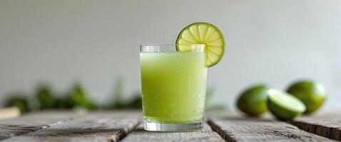 Fresh sugarcane juice with limes on rustic wood photo