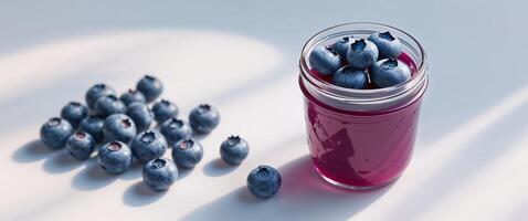 Refreshing blueberry juice in jar with fresh berries photo
