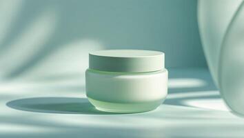 Serene Green Skincare Jar with Soft Shadows on Aqua Background photo