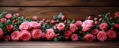 A bouquet of pink flowers is arranged on a wooden table. The flowers are of various sizes and colors, creating a vibrant and lively atmosphere photo