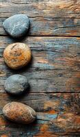 Colorful stones arranged neatly on wood. Smooth, colorful stones are placed on a rustic wooden surface, showcasing natural textures and earthy tones. photo