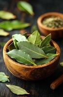 Bay leaves in a wooden bowl. Green bay leaves arranged neatly in a rustic bowl, showcasing their vibrant texture and color for culinary use. photo