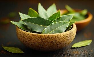 Fresh bay leaves in rustic wooden bowls. Green bay leaves are arranged neatly in natural wooden bowls, showcasing their vibrant color and texture. photo