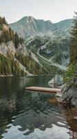 A wooden dock sits on the edge of a lake photo